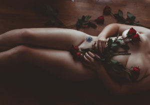 Granite Bay boudoir photography implied nude portraits with red roses covering naked body
