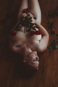 Granite Bay boudoir photography implied nude portraits with red roses covering naked body