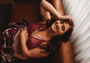 Rocklin boudoir photography woman laughing in lingerie on couch