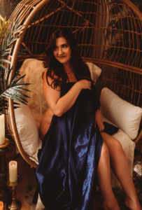 Rocklin boudoir photography wearing blue satin sheet for implied nude boudoir photoshoot