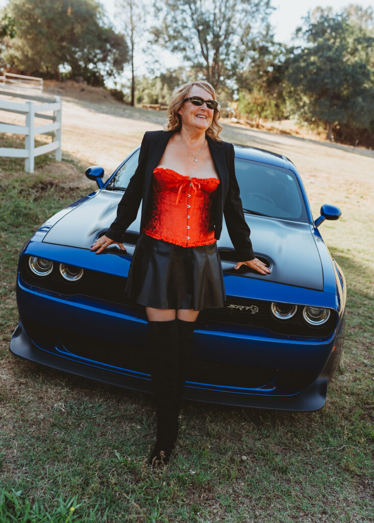 Outdoor Boudoir Photoshoot in Carmichael, California with older Woman in red corset lingerie and dodge hellcat - Limitless Boudoir