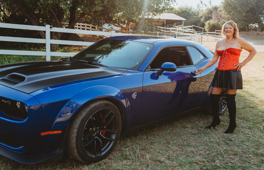 Outdoor Boudoir Photoshoot in Carmichael, California with older Woman in red corset lingerie and dodge hellcat - Limitless Boudoir