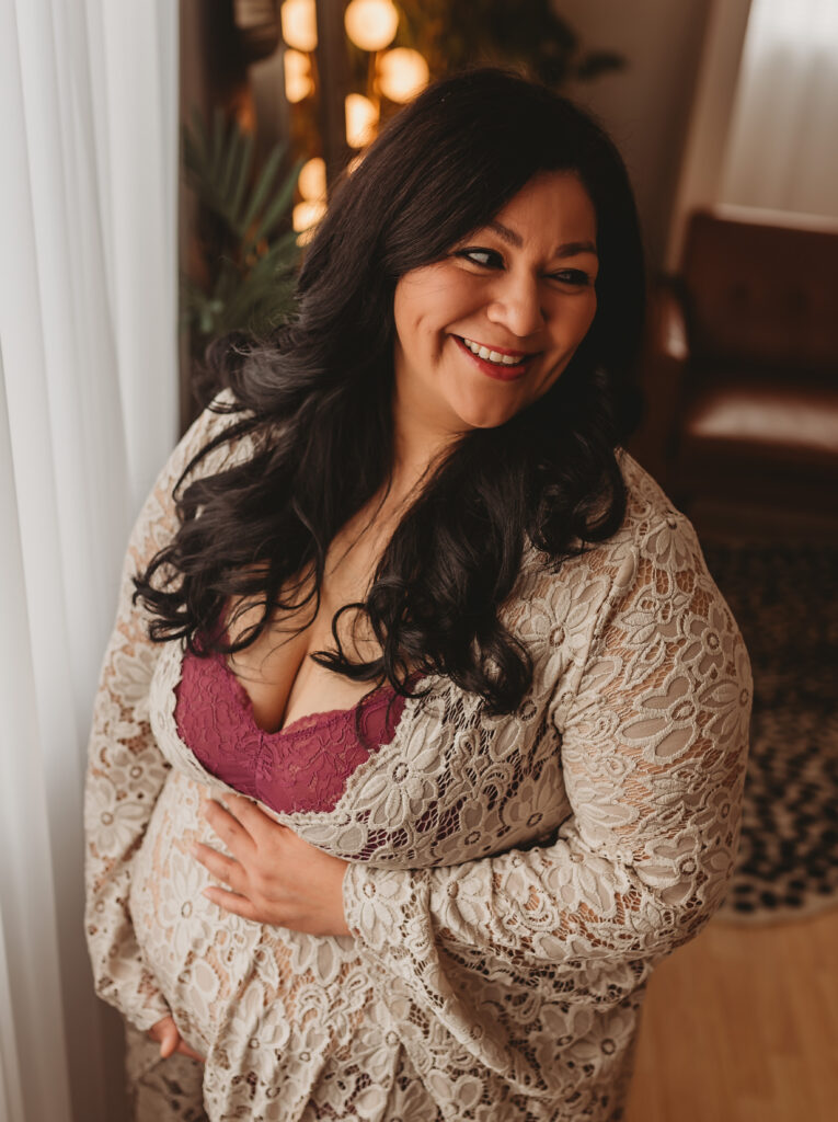 Mother's gentle smile amidst tears, conveying strength and love in maternity remembrance photography in Folsom CA.