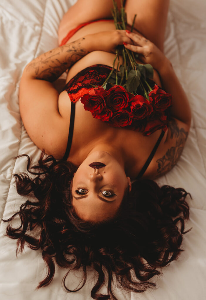 Client posing with red roses during a Valentine’s Day boudoir photoshoot in Sacramento.