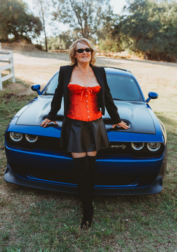 Outdoor Boudoir Photoshoot in Carmichael, California with older Woman in red corset lingerie and dodge hellcat - Limitless Boudoir